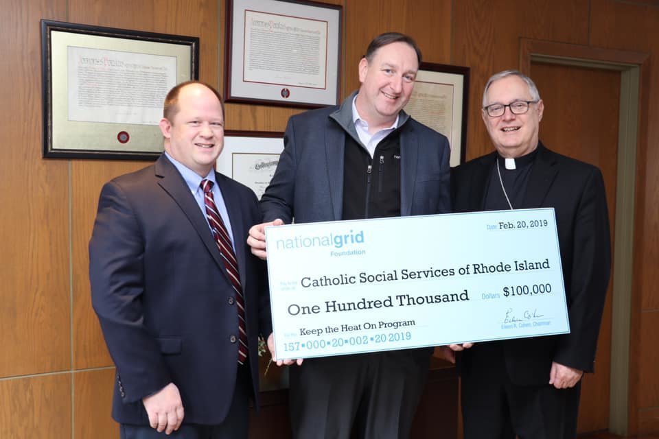 On Wednesday, Feb. 20, Ed White, center, executive director of the National Grid Foundation, presented a gift of $100,000 to support ‘Keep the Heat On’ to Bishop Thomas J. Tobin, and James Jahnz, program coordinator.